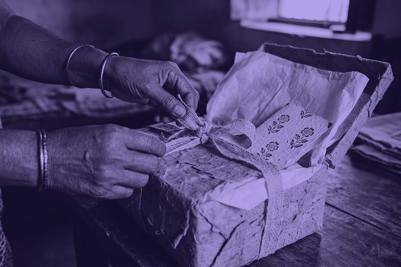 Hands opening a textured gift box